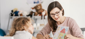 teacher with young girl talking