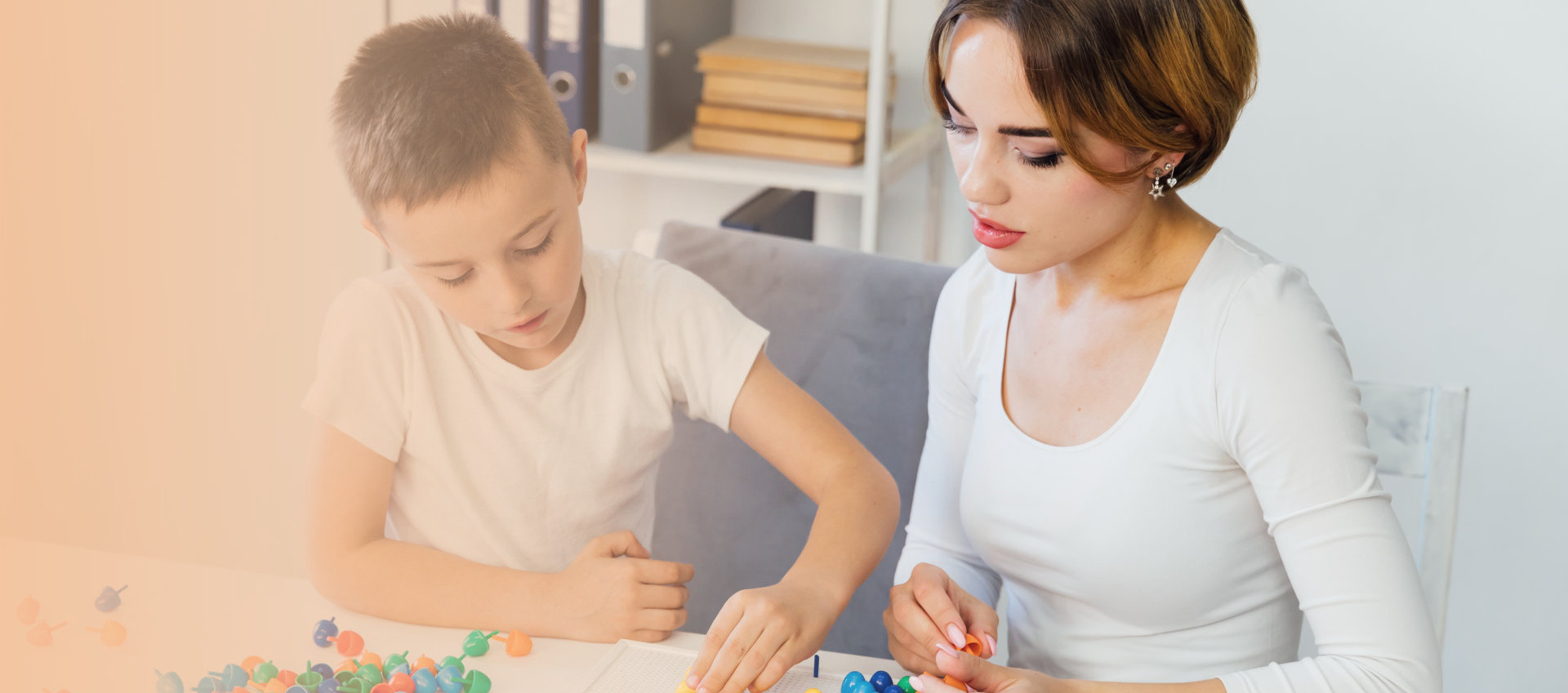 woman with young kid forming letters