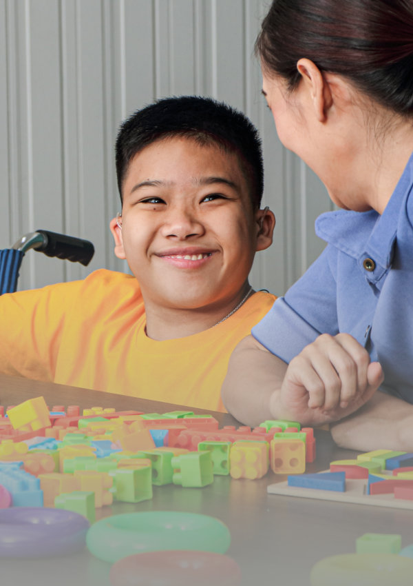 two kids and a woman playing blocks