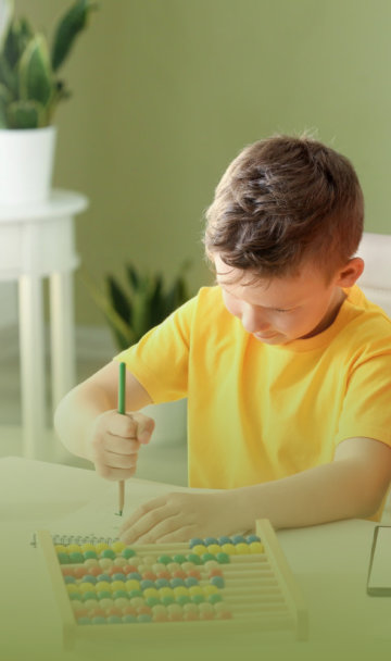 woman with young kid drawing using color pencils
