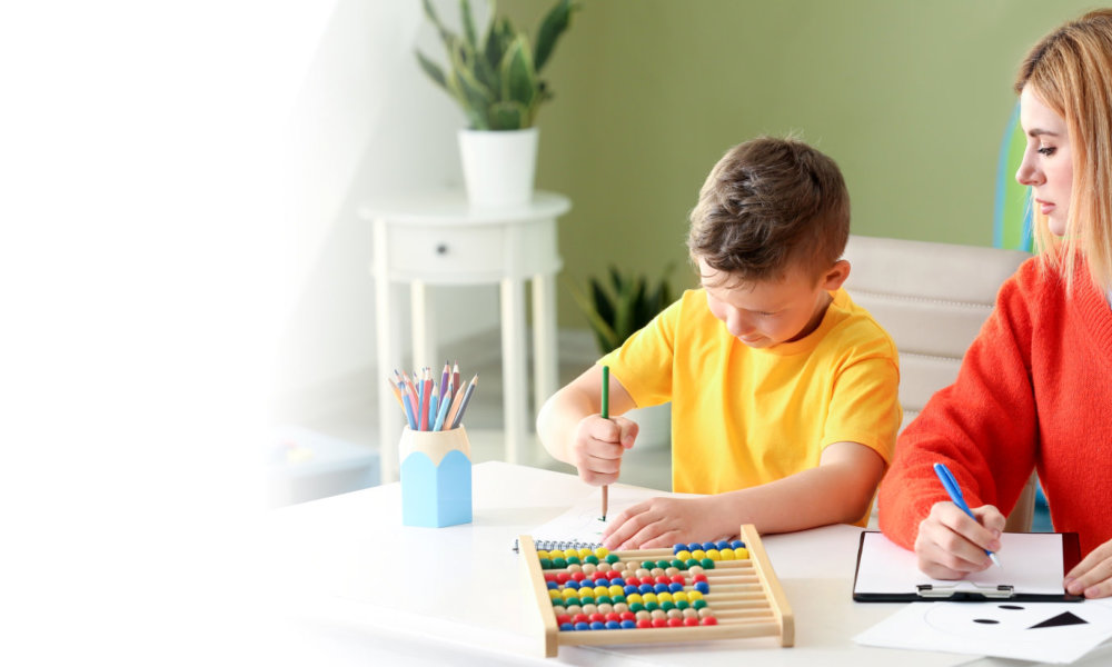 woman with young kid drawing using color pencils