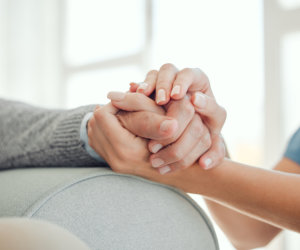 two person holds hands to each other