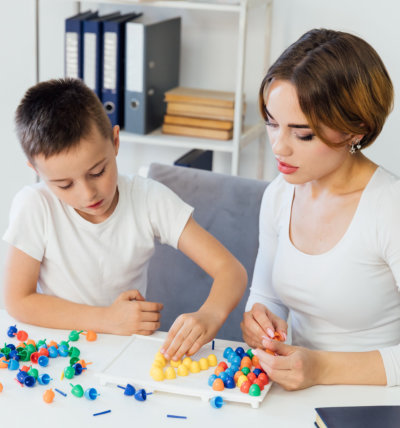 woman with young boy playing